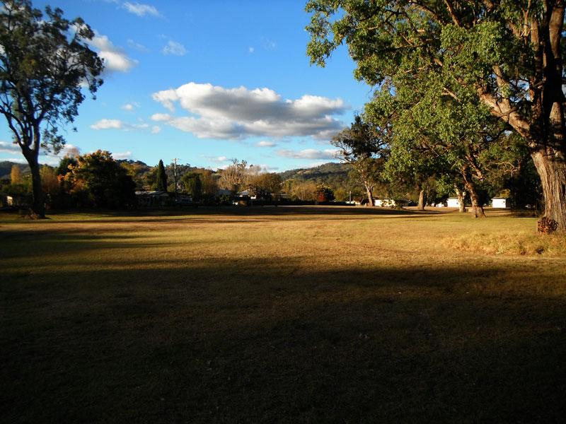 Large area closer to the creekTYhis area is past the toilets and picnic tables and is very large.